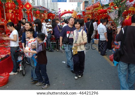 CHINA, SHENZHEN - FEBRUARY 10: Chinese people searching colorful decorations for Chinese New Year on February 10, 2010 in Shenzhen, China.