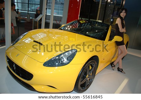 CHINA, SHENZHEN - JUNE 14: Shenzhen-Hong Kong-Macao Auto Show, Chinese model presents Ferrari on June 14, 2010 in Shenzhen.