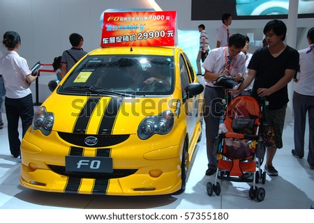 SHENZHEN - JUNE 14: Shenzhen-Hong Kong-Macao Auto Show, family watching BYD cars on June 14, 2010 in Shenzhen.
