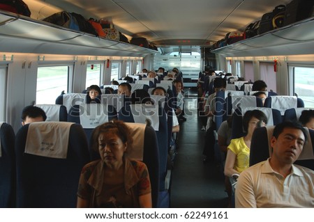 GUANGZHOU, CHINA - SEPT 29:Passengers inside the train on the way from Guangzhou to Wuhan on September 29, 2010 in Guangzhou. China invests in fast and modern railway, trains with speed over 340 km/h.
