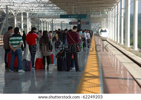 YUEYANG - HUNAN, CHINA - OCTOBER 3:Passengers wait for train to Guangzhou on October 3, 2010 in YueYang station. China invests in fast and modern railway, trains with speed over 340 km/h.
