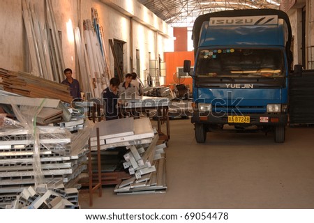 CANTON, CHINA - NOVEMBER 11: One of the biggest manufacturer of auto spray booths and generators in China. Workers unload truck with raw materials on November 11, 2010 in Canton, China.