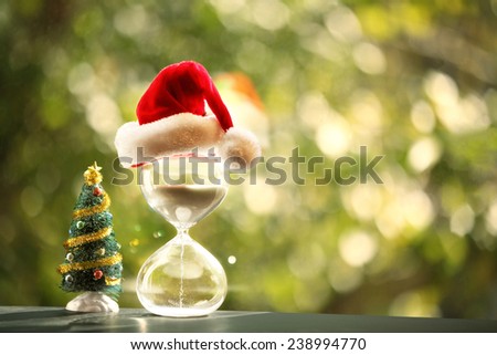 Christmas countdown. Modern Hourglass and Christmas tree -- sand trickling through the bulbs of a crystal sand glass.