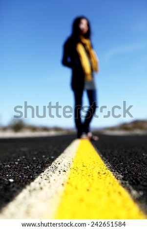 My way -- a lady standing in the middle of the road.