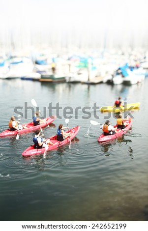 Kayaking teams compete. Tilt-shift photography.