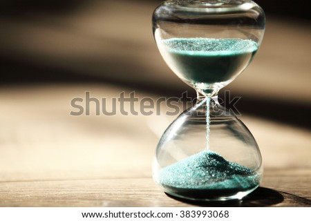 hourglass on wooden background,vintage color tone