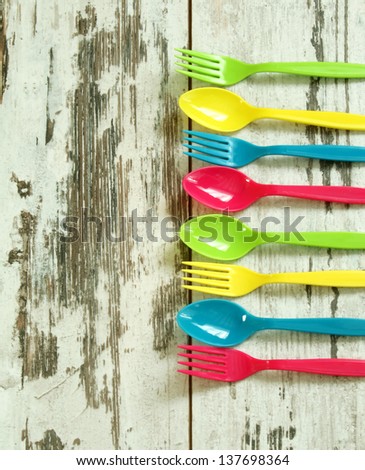 colorful plastic tableware on wooden boards