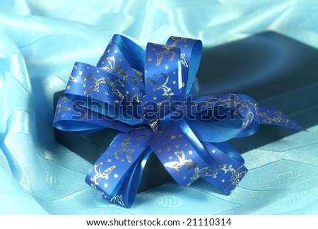 Gift box with a dark blue tape on a blue background