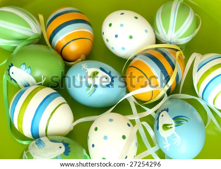 Easter eggs with  ornament on a green plate