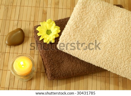 Spa background. towels, flower and candle