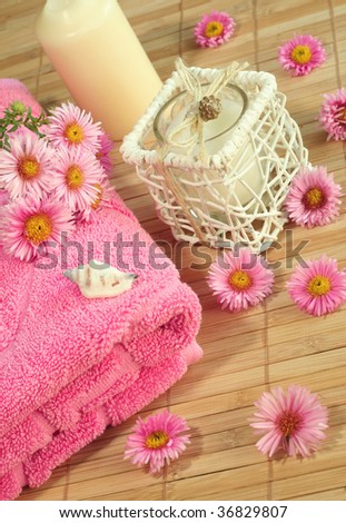 Spa composition. Towel, candle and flowers.