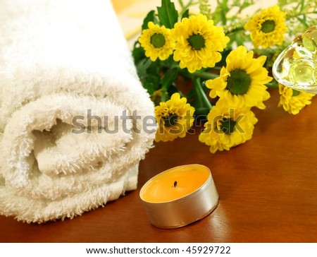 towel, yellow flowers and candle