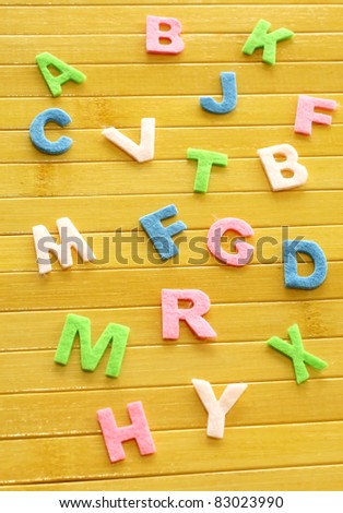 color letters on wooden background