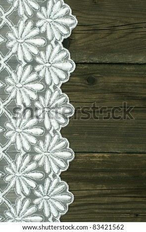 beautiful white lace with floral ornament on wooden boards
