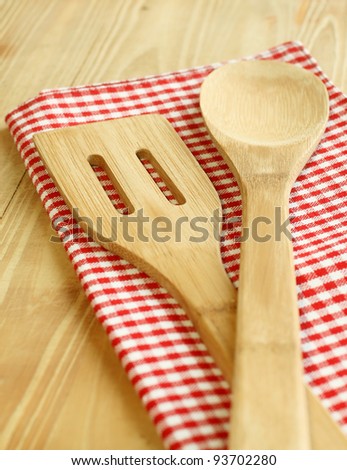 wooden serving spoons on checkered napkin