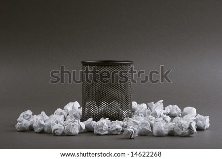 Recycle bin with crumpled papers