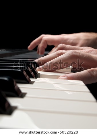Piano player over black background,closeup shot, shallow DOF