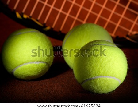tennis balls with the  racket in the background, low key, for tennis,recreation and sport themes