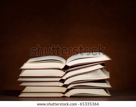 stack of opened books on the desk, for education,literature or studying themes
