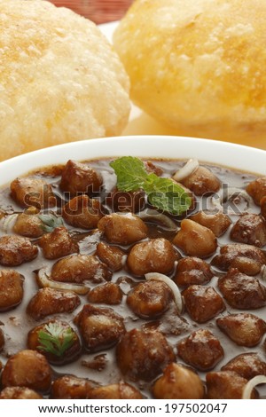Delicious chole with bhatura in background, Indian food
