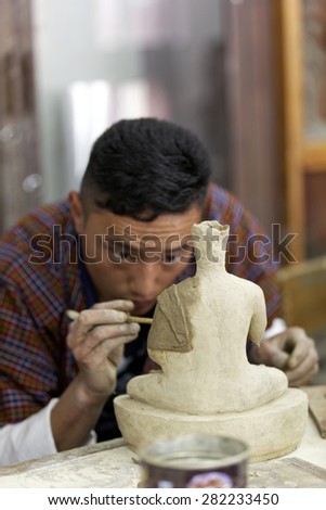 Student learning to create sculpture at arts and crafts school, Thimpu, BHUTAN, MAY 2015