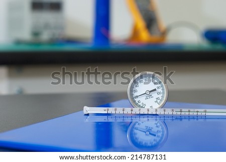 Close shot of two types of thermometers in electrical laboratory.