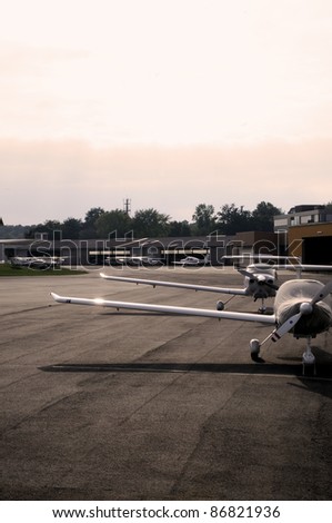 Small airplanes Small airplanes at a small airport standing in front of the hangars