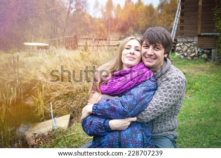 Couple of future parents about the country house in the autumn