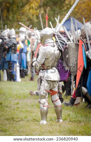 Knight in armor and a helmet with a long sword