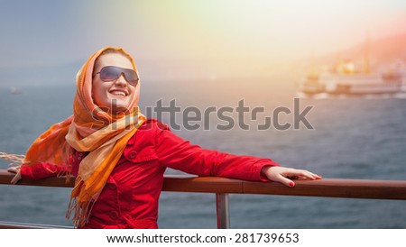 Girl in sunglasses enjoys the spring sun on the ferry in Bosporus