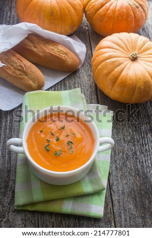 pumpkin and pumpkin soup on a wooden surface