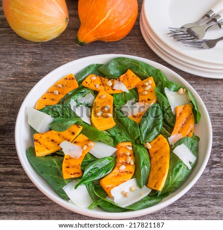 spinach salad with roasted pumpkin, pine nuts and cheese