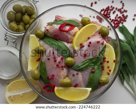 raw rabbit and spices - lemon, sage, pepper, Bay leaf, olives