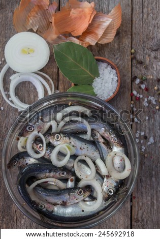 salted fish with spices and onions in a glass bowl