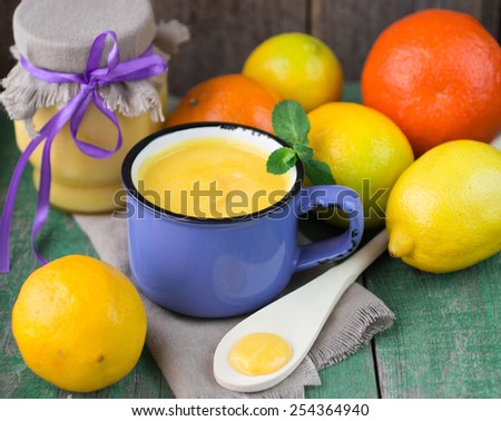 Lemon cream Kurd in a Cup and citrus on the table. soft focus