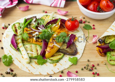 Tortilla and grilled vegetables - zucchini, eggplant, bell peppers, red onions, tomatoes and herbs