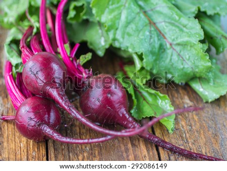 Fresh organic beets with water drops on an old wooden table