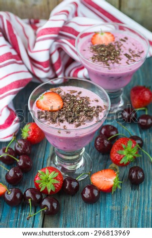 Smoothies. Milk dessert with cherries, strawberries and chocolate. Selective focus