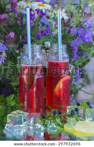 Berry lemonade. Summer cool drink of berries and citrus with ice. Selective focus