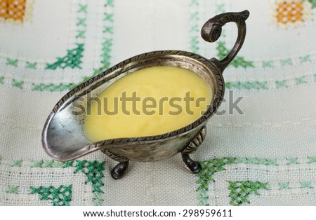 Traditional hollandaise sauce in a vintage gravy boat