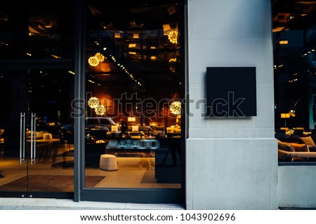 Main entrance of hotel, store or business company with mock up signboard with copy space area for your information Blank board of shop for add your design. City street with frontal door of store