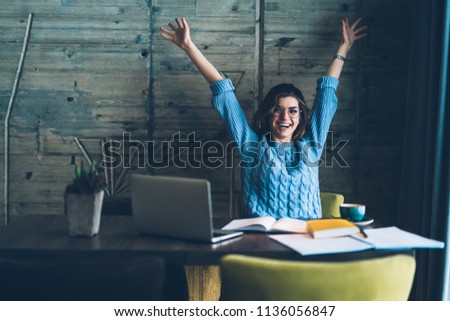 Happy female student feeling excited of e learning and preparing for exam at coworking space, successful woman making research in literature doing homework project via laptop computer indoors