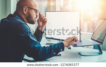 Businessman study financial market to calculate possible risks and profits. Male economist accounting money and research statistics graphs on laptop computer at office desktop. Quotations on exchange
