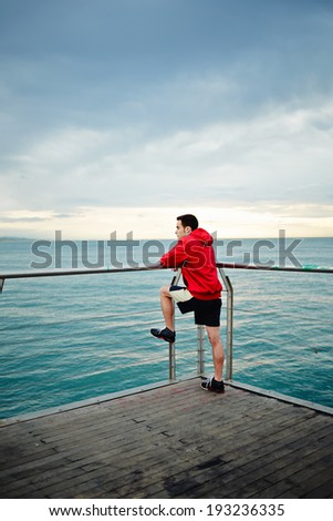 Legs of men who running along the pier