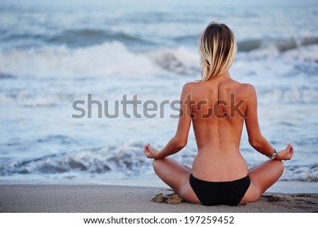 Slim girl doing yoga in a sitting posture, evening meditation