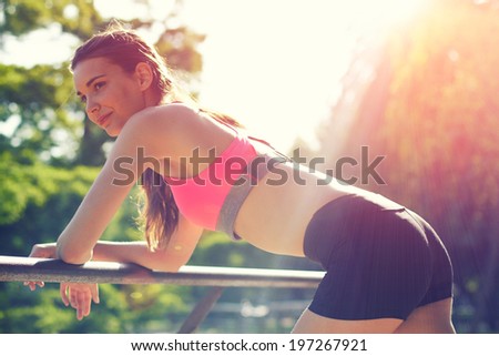 young woman leaned on the railing and resting after jog and yoga
