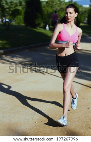 Young female athlete running runs cross country