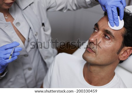 Beautiful man having wrinkles removed in a beauty clinic with cosmetic injection