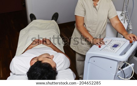 Patient lying in the medical cabinet of aesthetic clinic, rejuvenation procedure