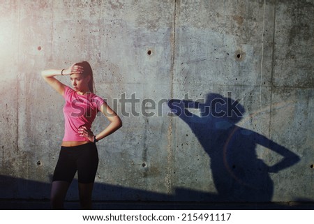 Beautiful athletic girl resting at sunset after intensive run outdoors, sports advertising and healthy lifestyle concept, fitness women taking break after jogging, tired women after intensive run